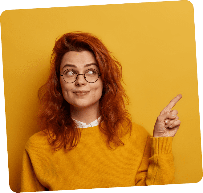 photo lovely ginger woman points index finger aside demonstrates promo right looks with interesting expression has wavy red hair 1 1